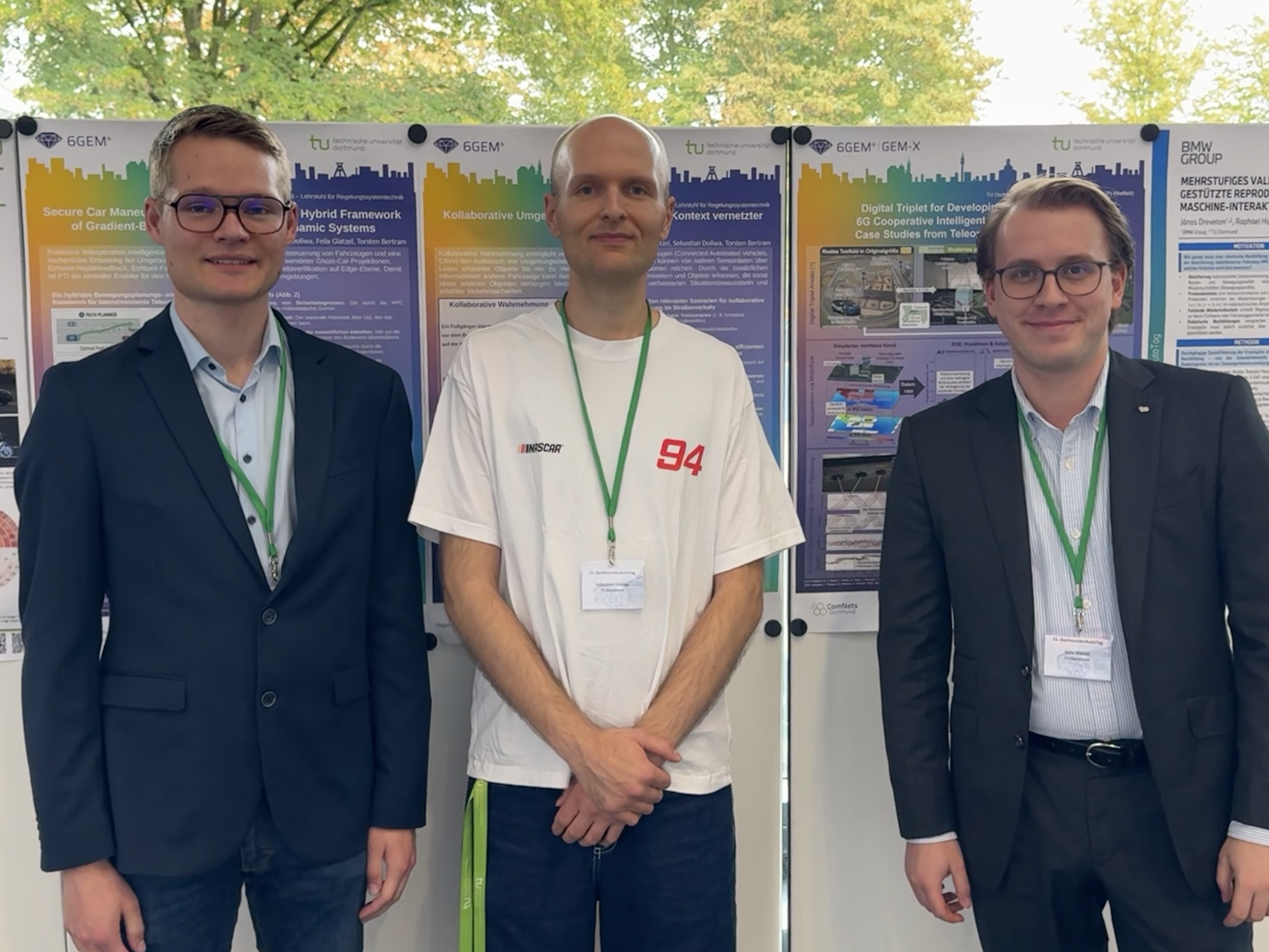 Three participants standing in front of the 6GEM+ research posters
